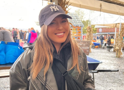 Young woman in baseball cap smiling