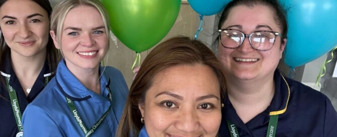 a group of nurses with balloons in the background